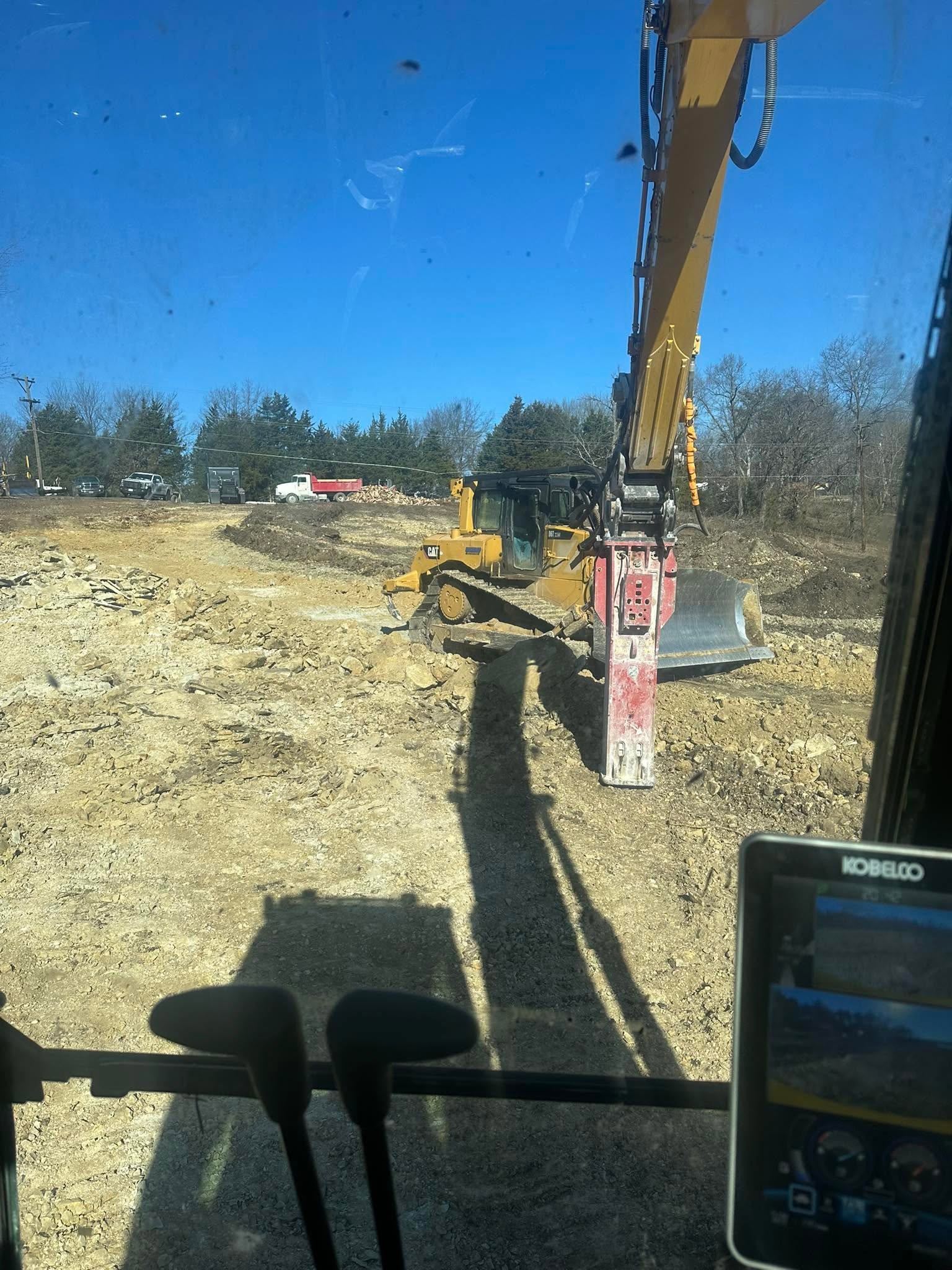Excavator digging a residential pond in Henry County, Missouri Excavator digging a residential pond in Henry County, Missouri