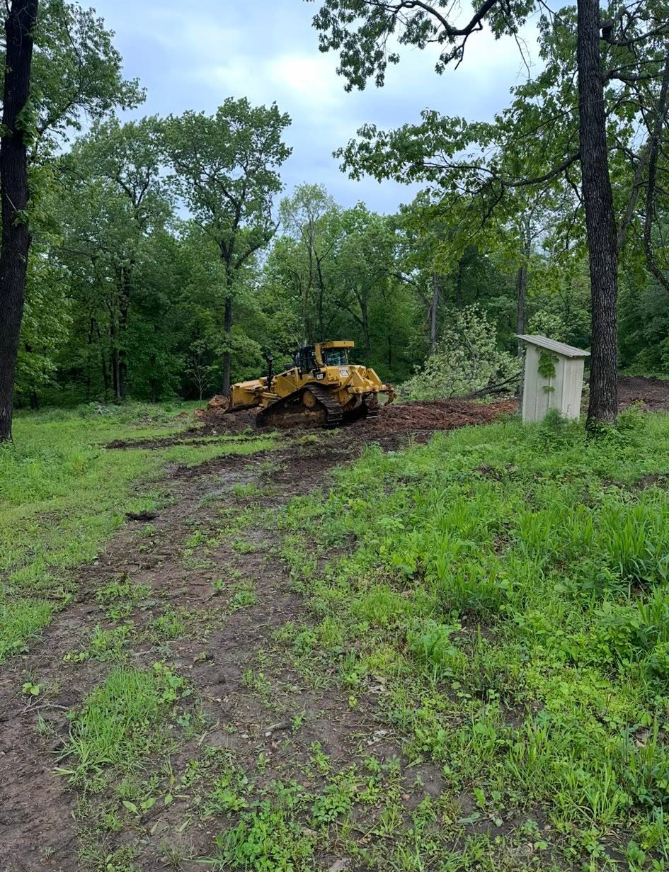 Excavation contractor shaping drainage ditches in Windsor, MO Excavation contractor shaping drainage ditches in Windsor, MO