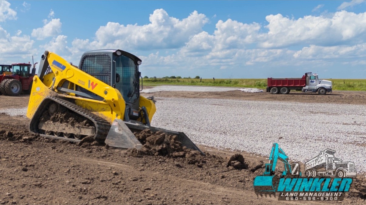 Compact track loader moving soil for site-prep near Windsor, MO Compact track loader moving soil for site-prep near Windsor, MO