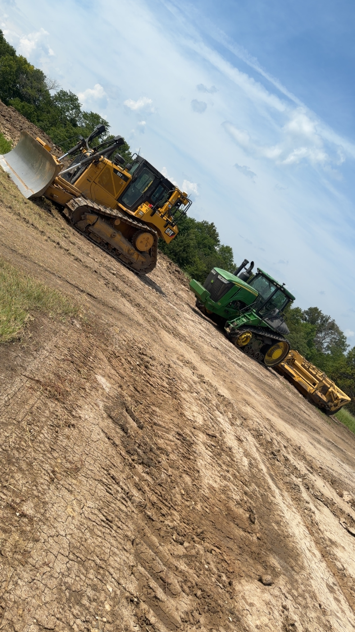 CAT bulldozer and tracked scraper grading land in Henry County, Missouri CAT bulldozer and tracked scraper grading land in Henry County, Missouri